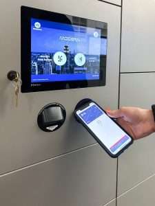 A user assigning an office smart locker via a touchscreen or mobile app.